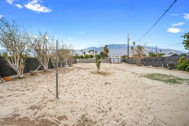 view of yard featuring a mountain view and a shed