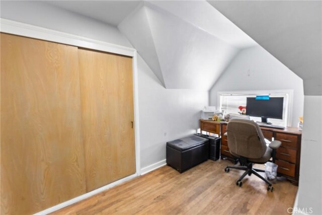 office space with lofted ceiling and hardwood / wood-style flooring