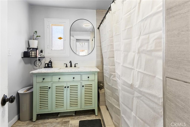 bathroom featuring walk in shower and vanity