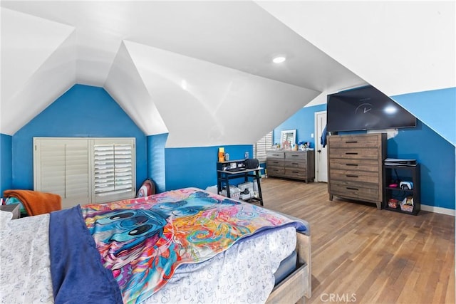 bedroom with hardwood / wood-style flooring and vaulted ceiling