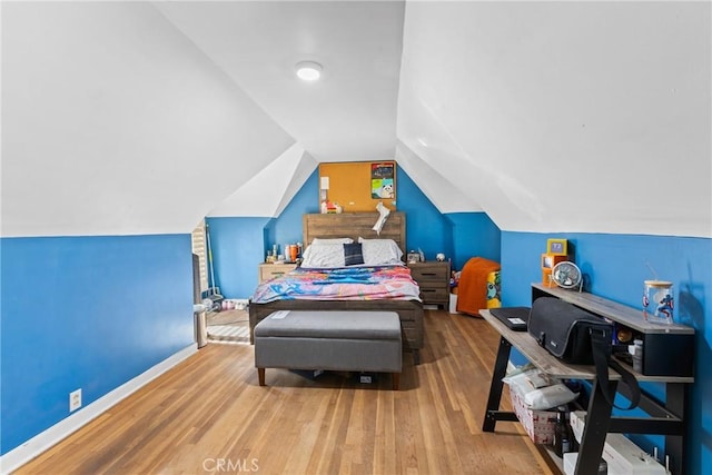 bedroom featuring lofted ceiling and wood-type flooring