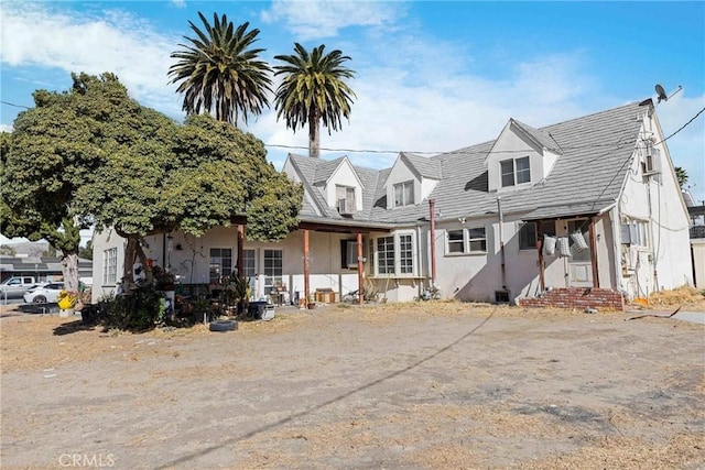 cape cod-style house with stucco siding