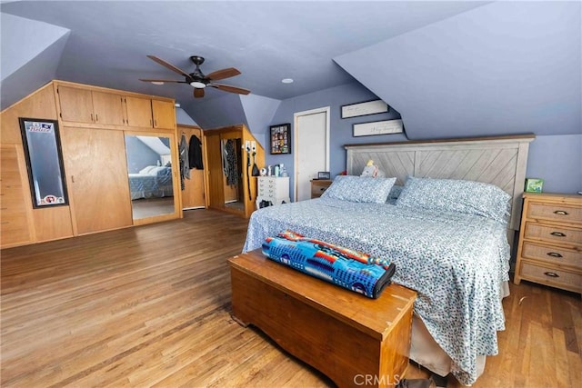 bedroom with ceiling fan, lofted ceiling, and light hardwood / wood-style flooring