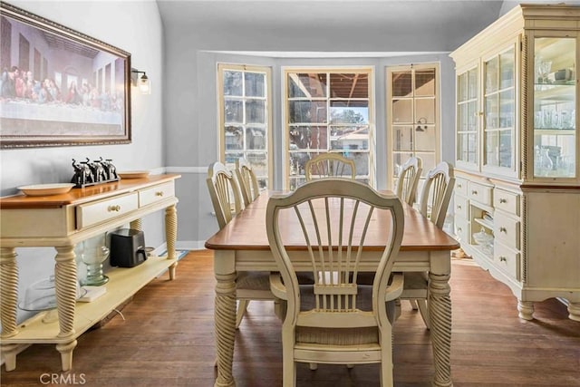 dining space with hardwood / wood-style flooring