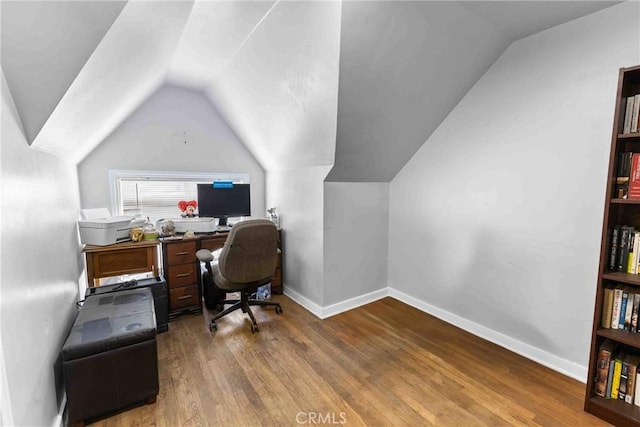 office space with vaulted ceiling, wood finished floors, and baseboards