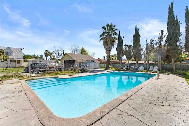 view of swimming pool with a residential view, a fenced in pool, a patio, and fence