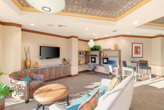 carpeted living room featuring built in desk, crown molding, and a tray ceiling