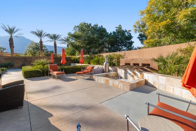 view of patio / terrace featuring an outdoor kitchen and a mountain view