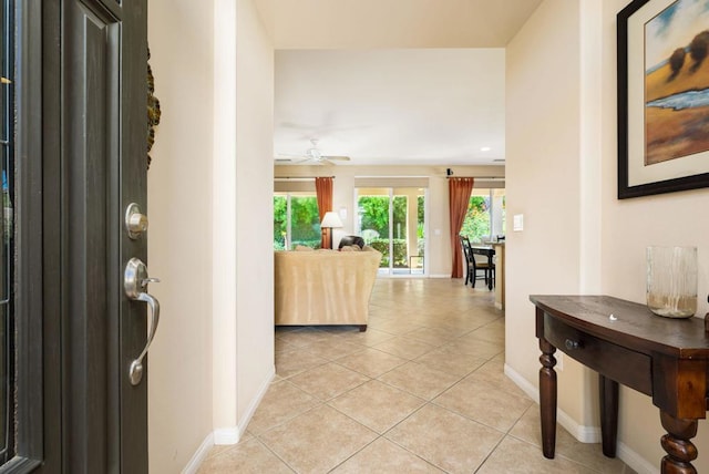 tiled entrance foyer featuring ceiling fan