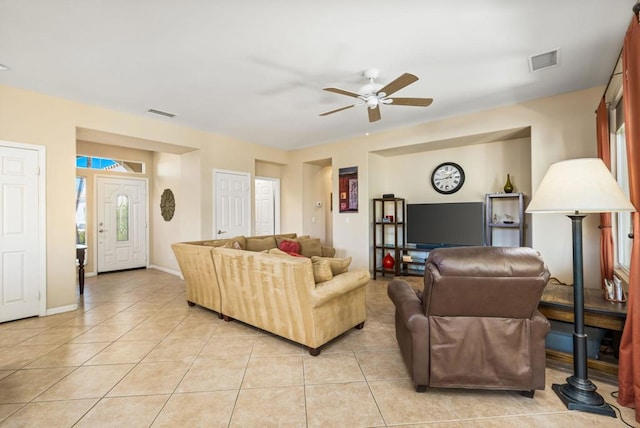 tiled living room with ceiling fan