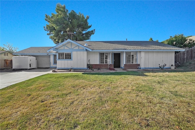 ranch-style home with a garage and a front lawn