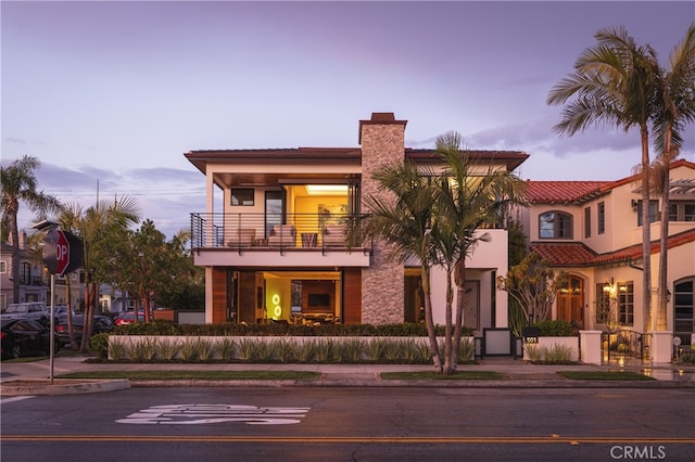 view of front of house featuring a balcony