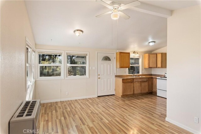 kitchen featuring lofted ceiling with beams, white electric range, ceiling fan, a wall mounted AC, and light hardwood / wood-style floors