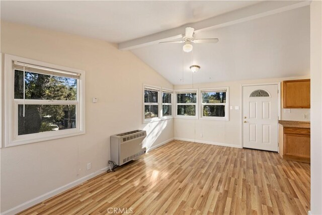 interior space with heating unit, lofted ceiling with beams, ceiling fan, and light hardwood / wood-style floors