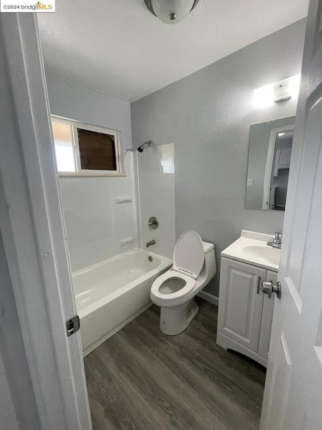 full bathroom featuring tub / shower combination, vanity, toilet, and hardwood / wood-style flooring