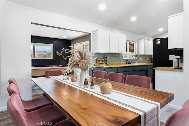 dining space with pool table, sink, and hardwood / wood-style floors