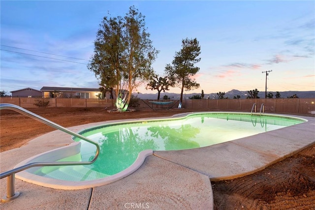 view of pool at dusk