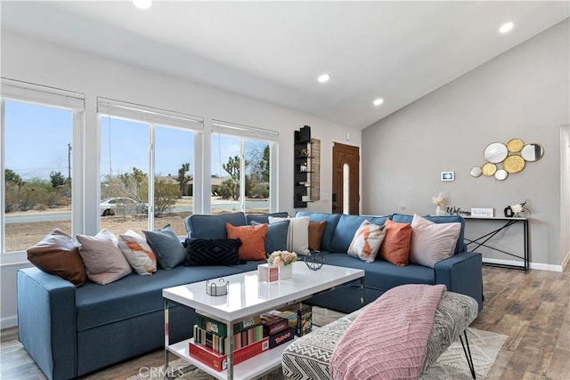 living room featuring vaulted ceiling and light hardwood / wood-style flooring