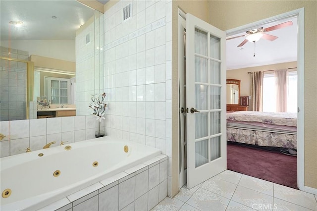 bathroom with french doors, ceiling fan, plus walk in shower, tile patterned flooring, and lofted ceiling