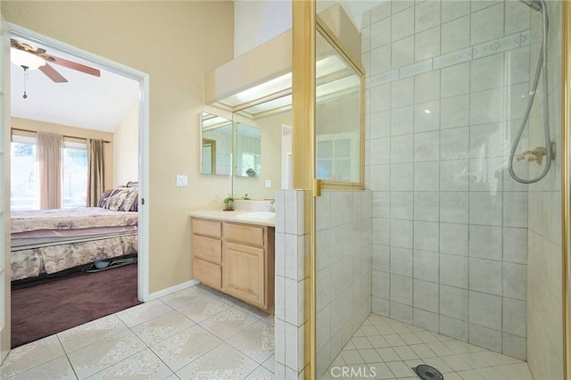 bathroom with tile patterned floors, ceiling fan, vanity, and a tile shower