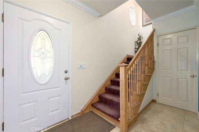 tiled foyer entrance with ornamental molding