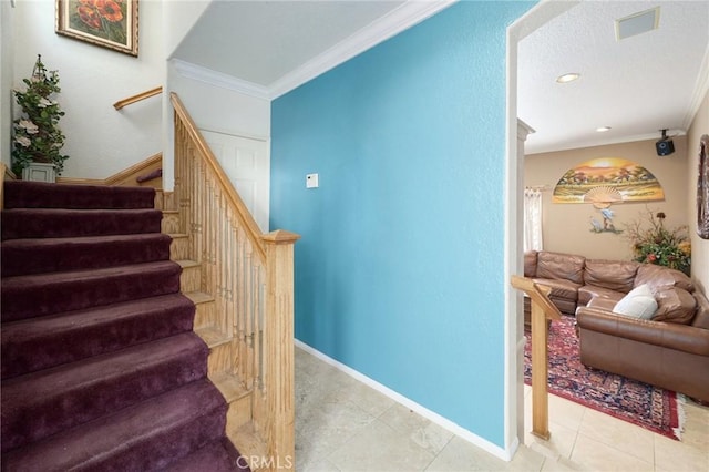 staircase with tile patterned floors and crown molding