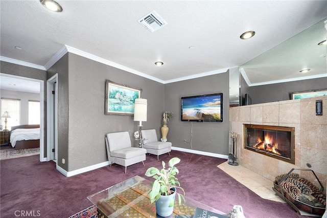 living room featuring dark colored carpet, ornamental molding, and a fireplace