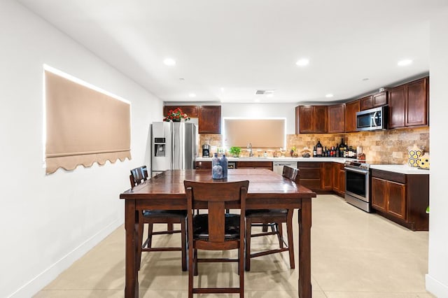 dining room featuring light tile patterned floors and sink