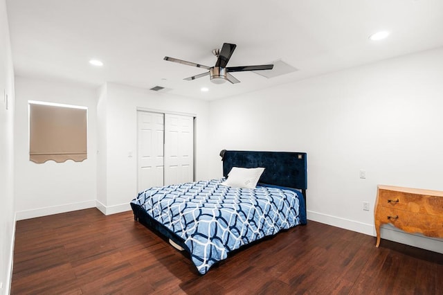 bedroom with ceiling fan, dark hardwood / wood-style flooring, and a closet