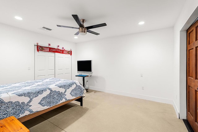 bedroom featuring a closet, ceiling fan, and light colored carpet