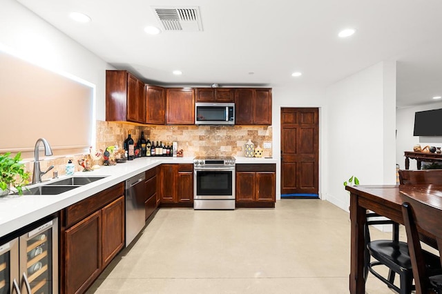 kitchen with tasteful backsplash, sink, beverage cooler, and stainless steel appliances