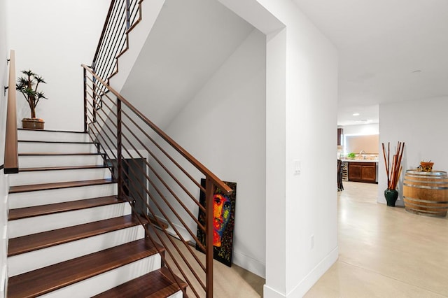 staircase featuring concrete floors