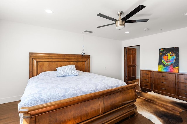 bedroom with dark hardwood / wood-style floors and ceiling fan