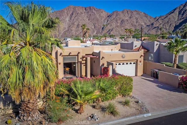 view of front of property featuring a mountain view and a garage