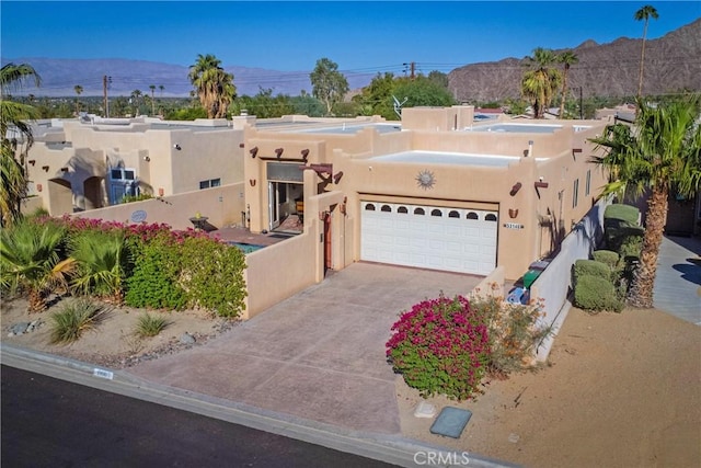 southwest-style home with a mountain view and a garage