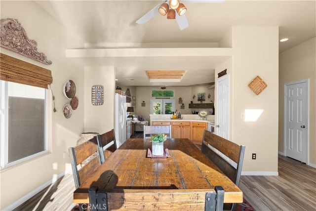 dining space featuring ceiling fan and wood-type flooring