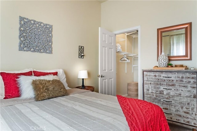 bedroom featuring a walk in closet and a closet