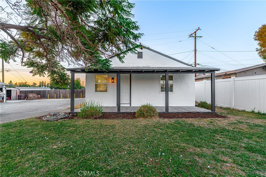 rear view of property with a lawn