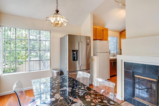 kitchen featuring hanging light fixtures, appliances with stainless steel finishes, vaulted ceiling, and plenty of natural light