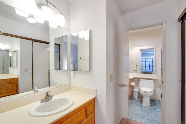 bathroom with tile patterned floors, vanity, and toilet