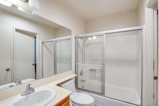 full bathroom featuring vanity, toilet, and enclosed tub / shower combo