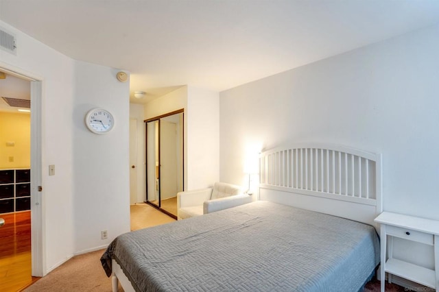 bedroom featuring light hardwood / wood-style flooring and a closet