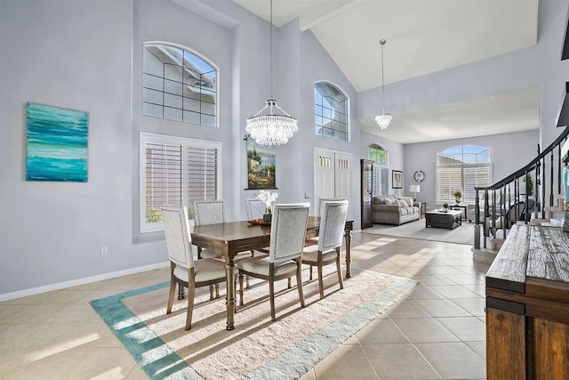 tiled dining room featuring a wealth of natural light, beamed ceiling, high vaulted ceiling, and a chandelier