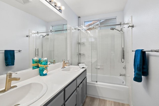 bathroom featuring vanity, combined bath / shower with glass door, and hardwood / wood-style flooring