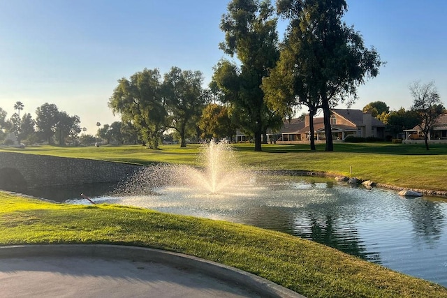 view of home's community featuring a yard and a water view