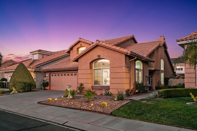 mediterranean / spanish-style house with a garage