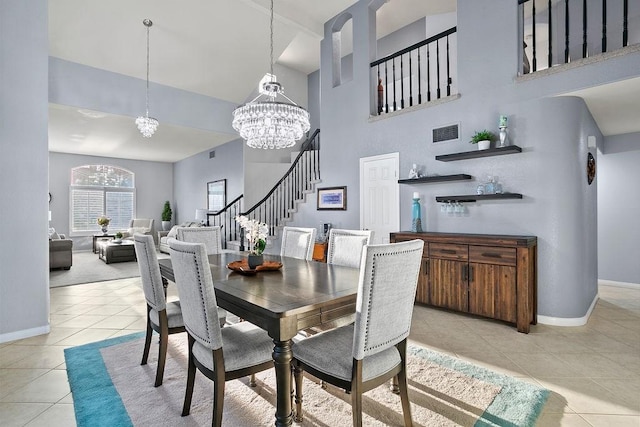 tiled dining room with a towering ceiling and a notable chandelier