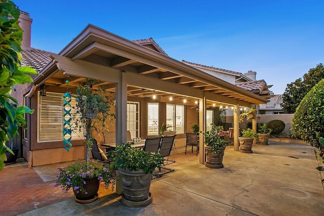 view of patio terrace at dusk