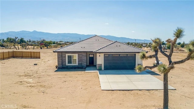 view of front of home featuring a mountain view and a garage