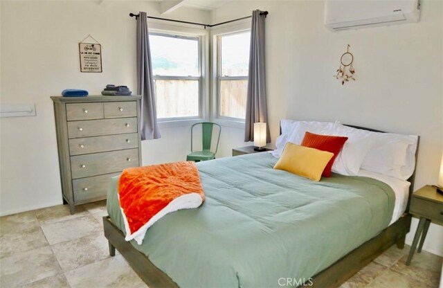 bedroom featuring a wall unit AC and beamed ceiling